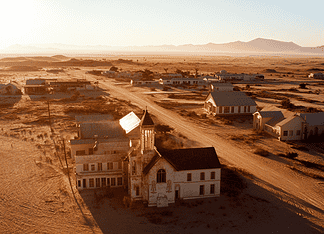 The Legend of Kolmanskop: The Diamond Kingdom Beneath the Sands Illustration of Kolmanskop, a mythical realm inspired by Kolmanskop, central to folklore.